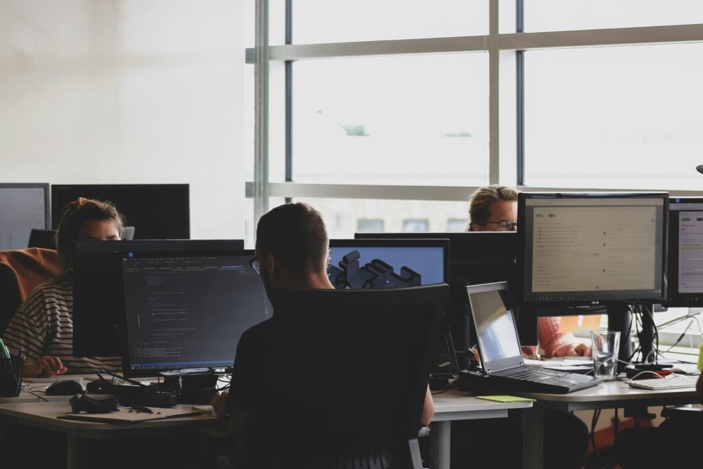 Business technology team working at computer screens in a modern office