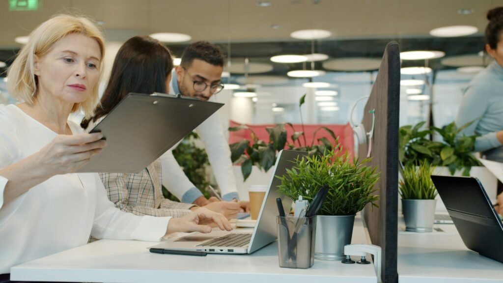 Business team working together with laptops in a modern office
