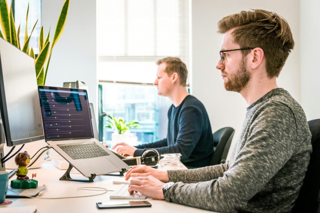 Small business employees using laptops in a professional office