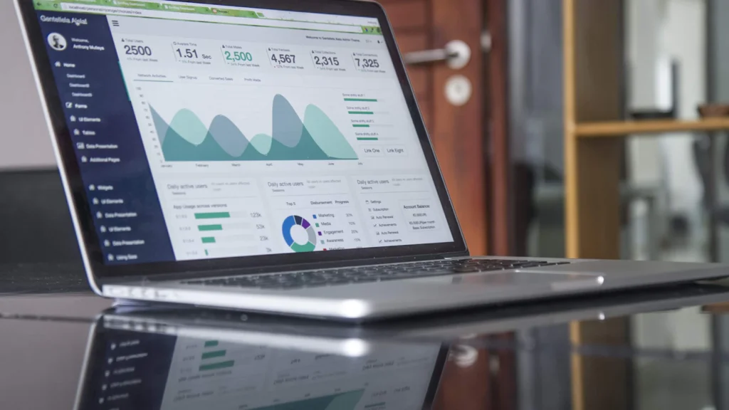 Business analytics graphs displayed on a laptop for reporting